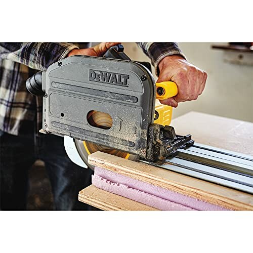 Person using a DeWalt track saw to cut wood.