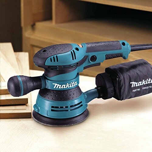 Makita random orbit sander on wooden surface